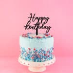 Eye-catching acrylic happy birthday cake topper on a colourful cake