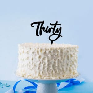 Elegant thirty cake topper on a deliciously frosted white birthday cake
