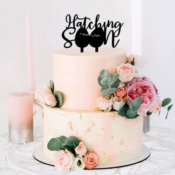 hatching soon cake topper in black acrylic on a 2 tier blush cake