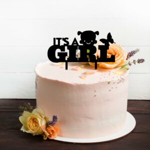 it's a girl cake topper in black acrylic on a blush pink cake.