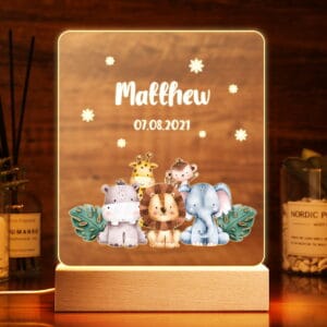 front view of a lit personalised name night light AU showcasing a safari design and custom name and date on a dark background